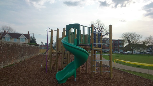 climbing frame with a green slide