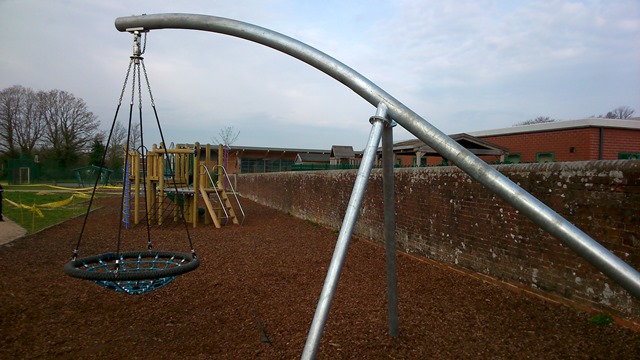 a basket swing by a wall